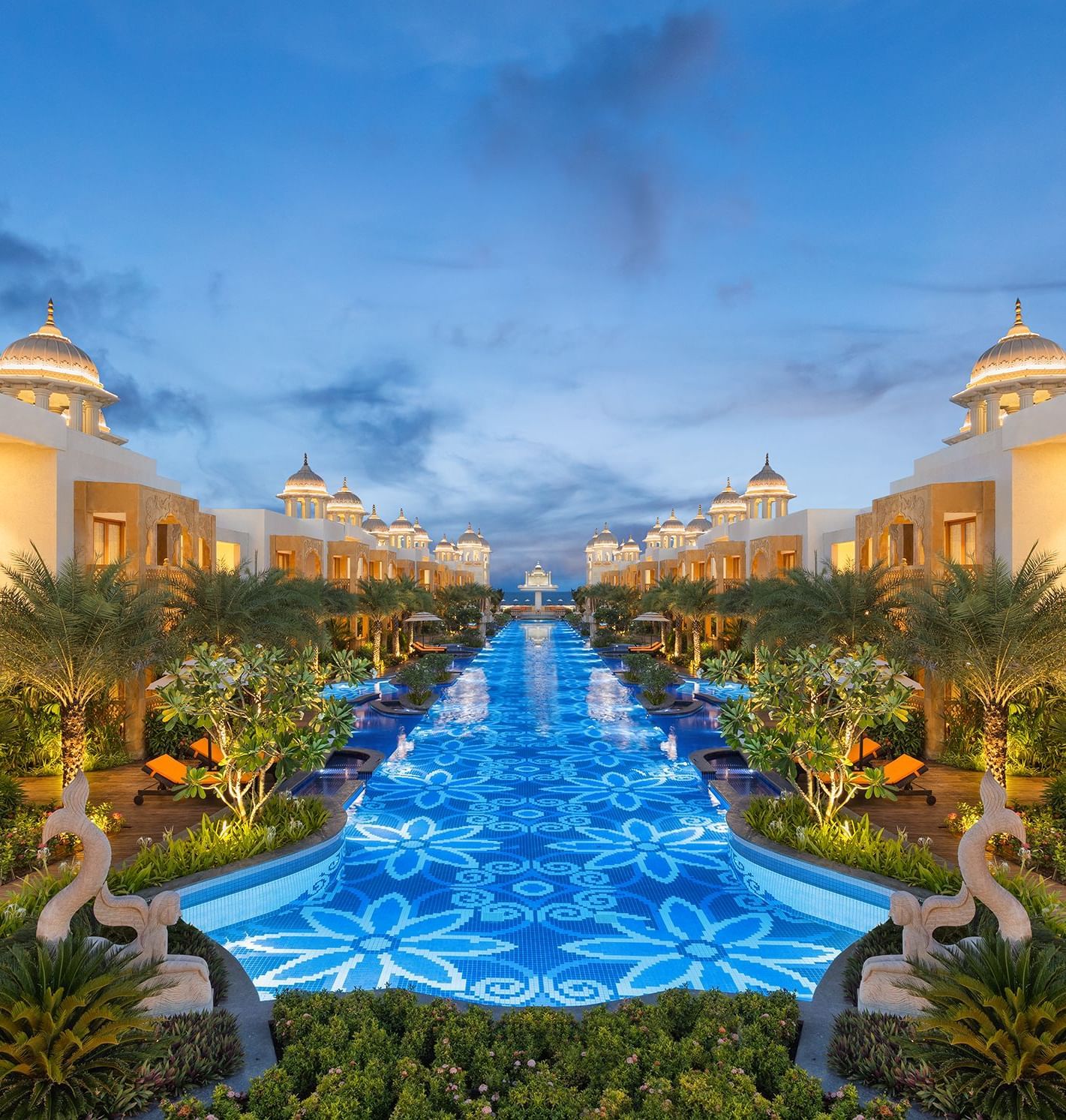 A view featuring a pool lit in blue colour with buildings of rajasthani architecture on either sides - Kaldan Samudhra Palace
