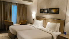 Well-appointed suite bedroom at Royal Hometel Suites, Dahisar, Mumbai showcasing cozy lighting and elegant decor.