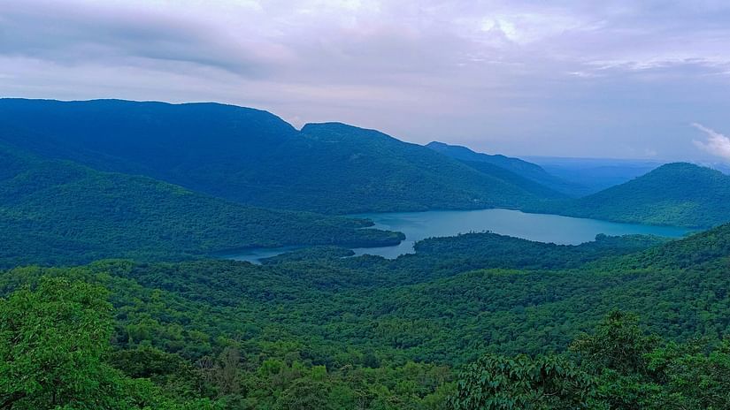An overview of Chorla Ghats with forest cover and a river flowing