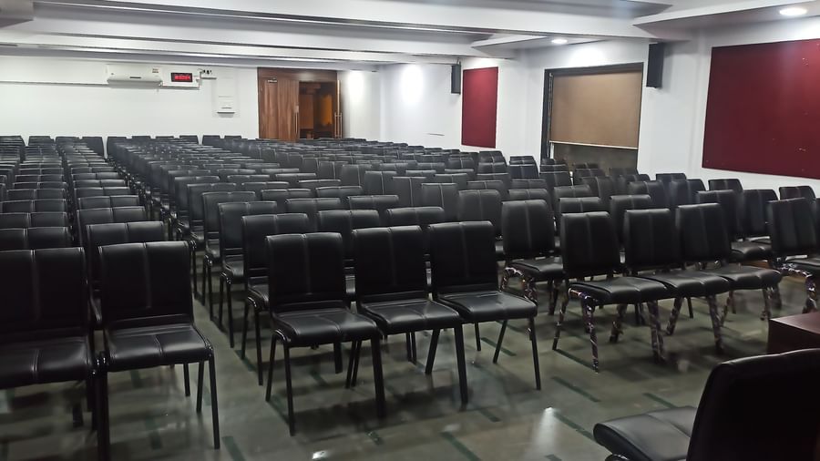 Theatre style seating arrangement with rows of black chairs in a rectangular hall at Mayur Retreat.