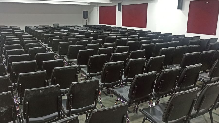 Theatre-style seating arrangement with black chairs lined in rows, set up for a seminar or conference at Mayur Retreat.