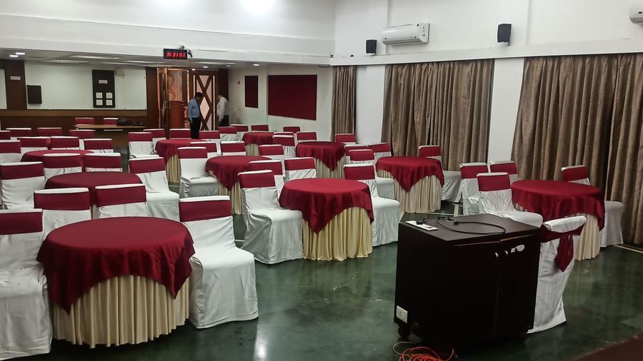 Cluster seating arrangement with multiple round tables and cushioned chairs at Mayur Retreat.