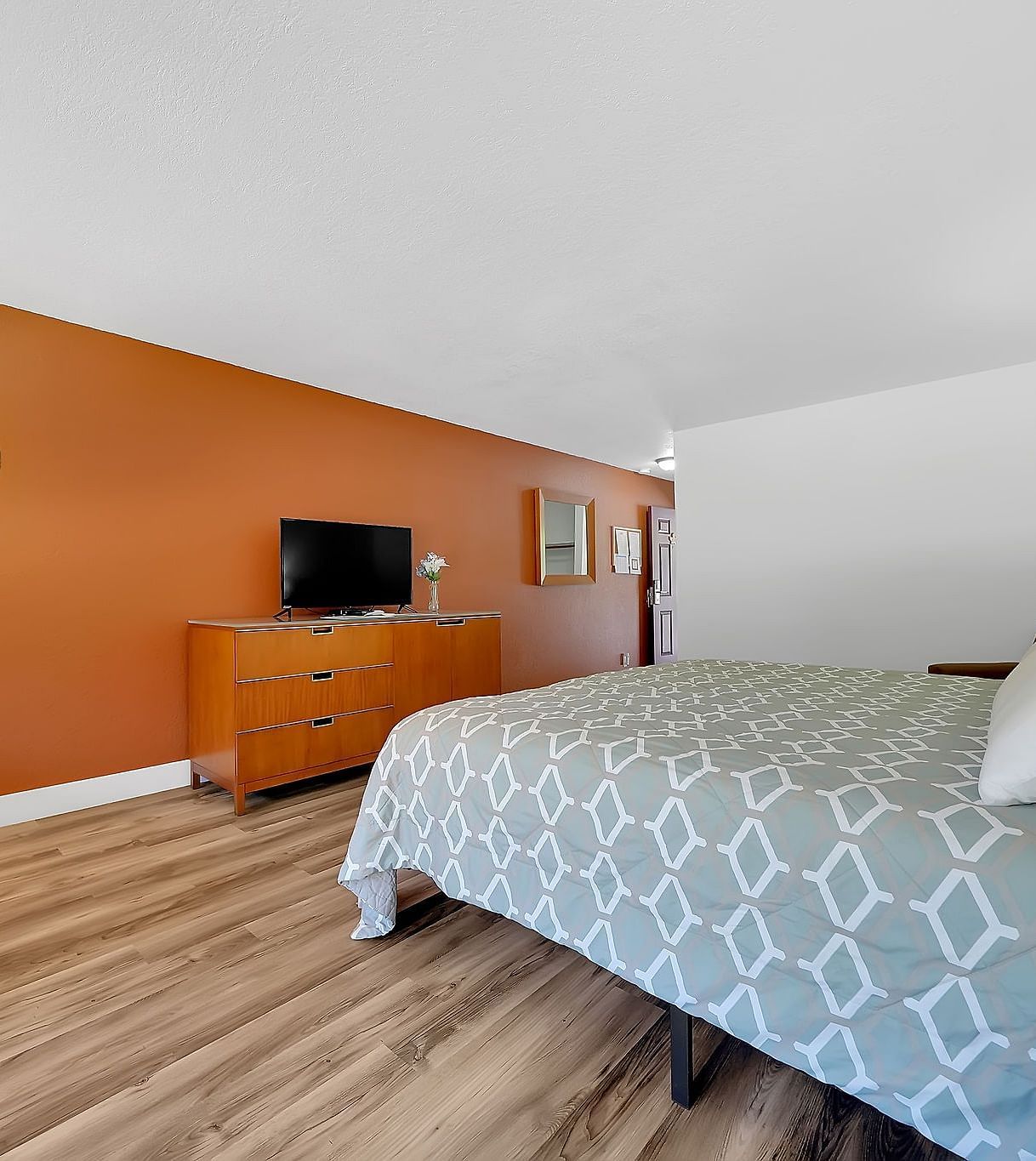 A view of a room at Amador Hotel with a double bed and a television.