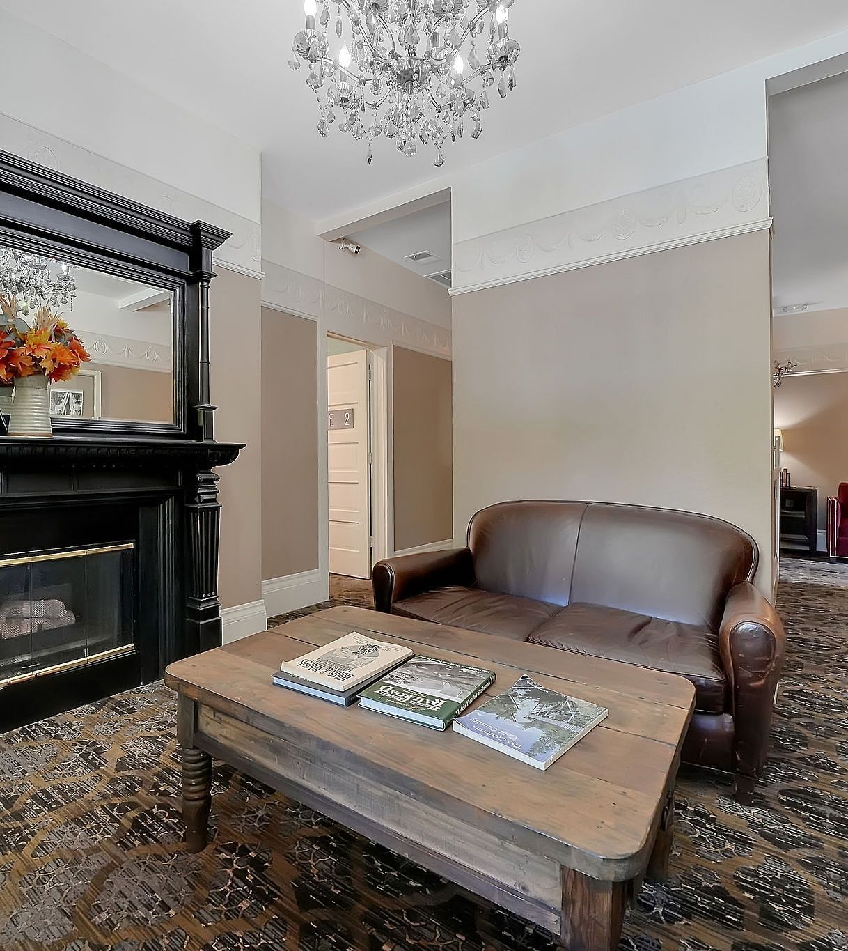 Living room area of a suite at The Groveland Hotel with sofa seating and a coffee table.