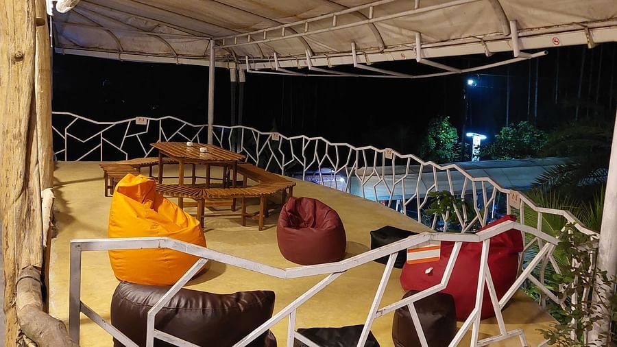 Relaxing outdoor lounge with colorful bean bags illuminated at night - Matsya Island Retreat by Island Quest.