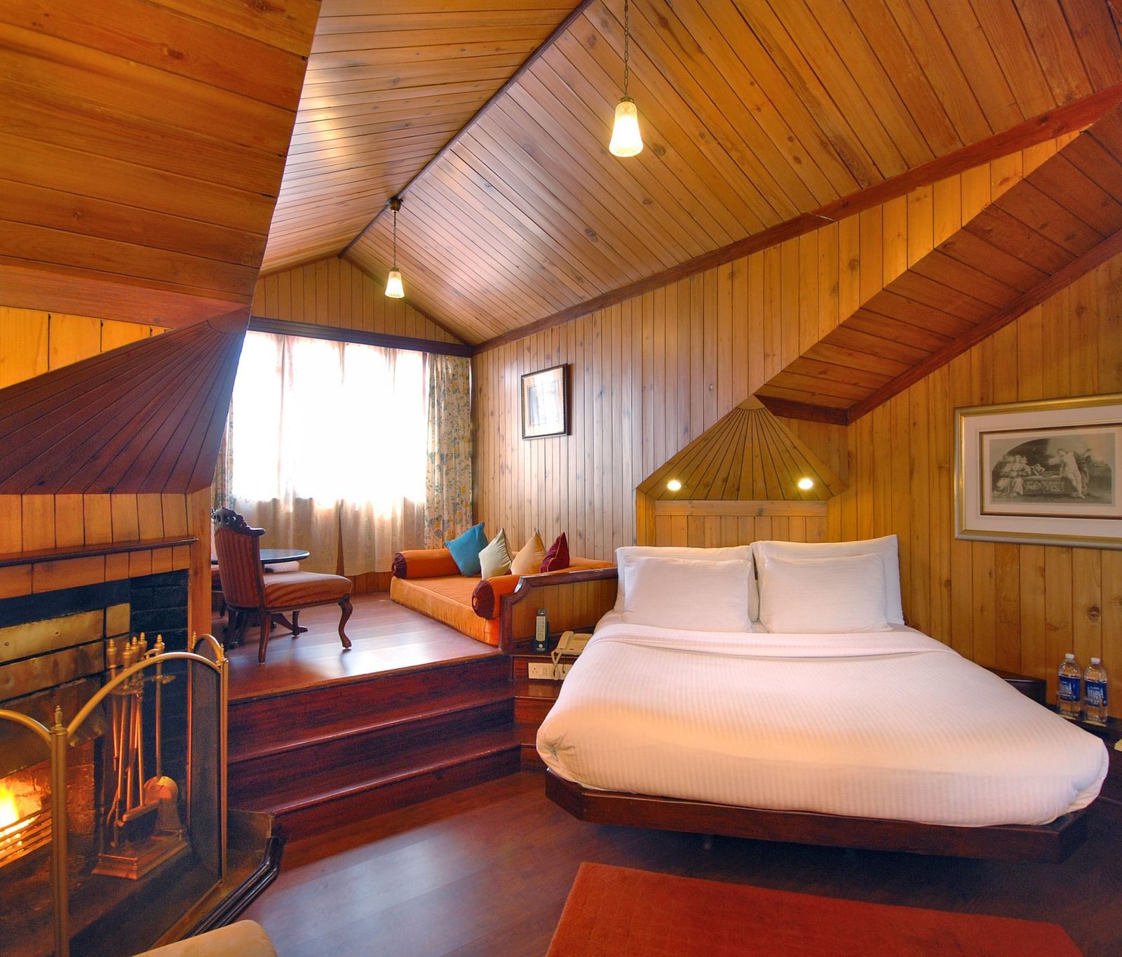 a king size bed and a fireplace to the left - Mayfair Hill Resort, Darjeeling