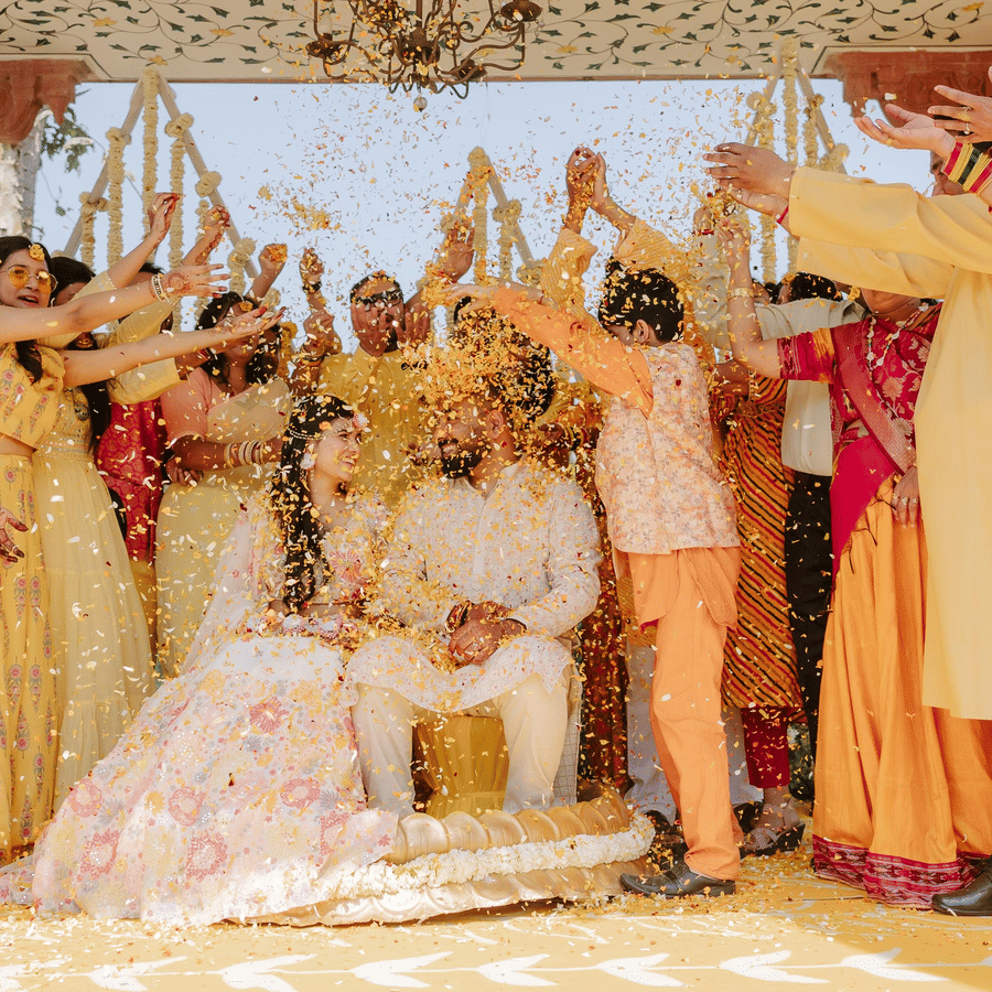 Family and friends celebrating a joyful haldi ceremony with the couple at Umaid Palace.