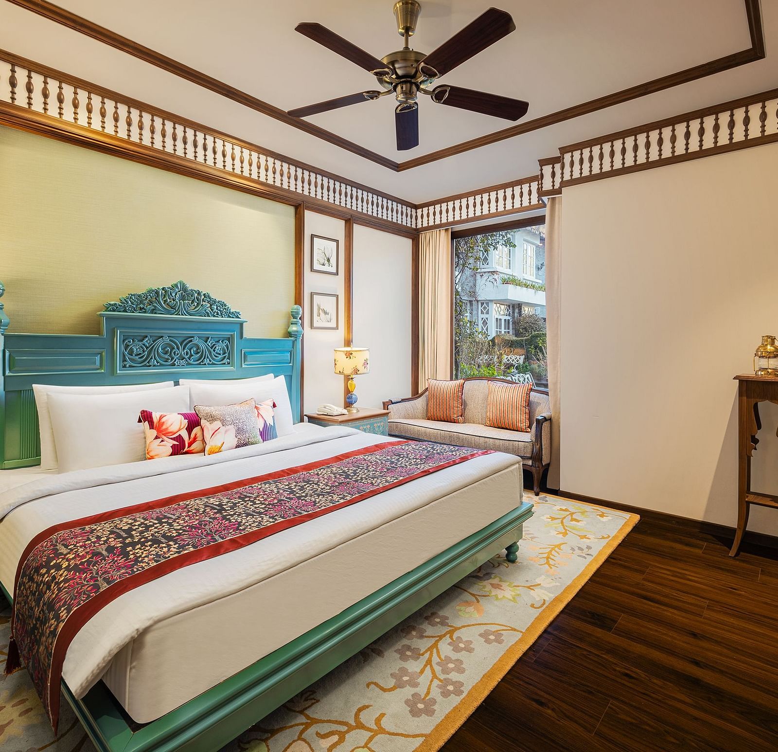 A suite room with a king size bed, elegant wall decors a five leafed fan, a flat screen TV, and multiple wall hangings - The Naini Retreat, Nainital