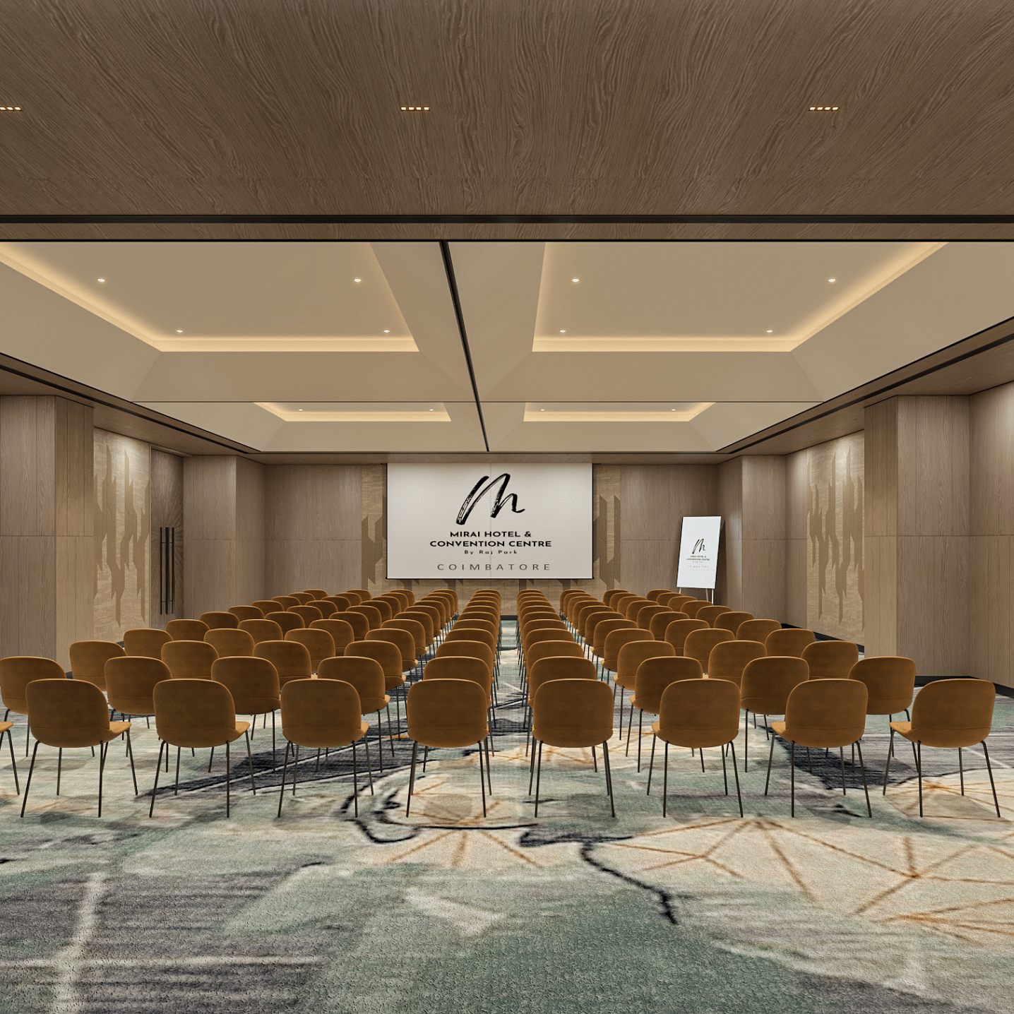 A theatre style arrangement of chairs, carpet, modern ceiling lights and projector upfront.