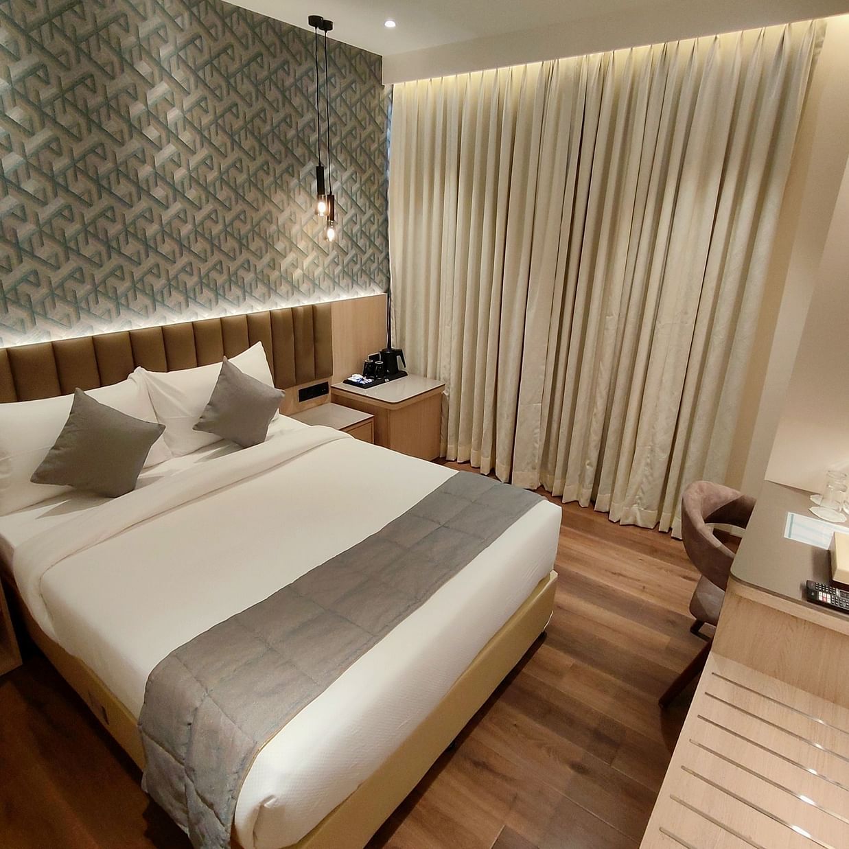 Wide angle view of deluxe room at Maxxvalue Hotel MIDC,  Mumbai