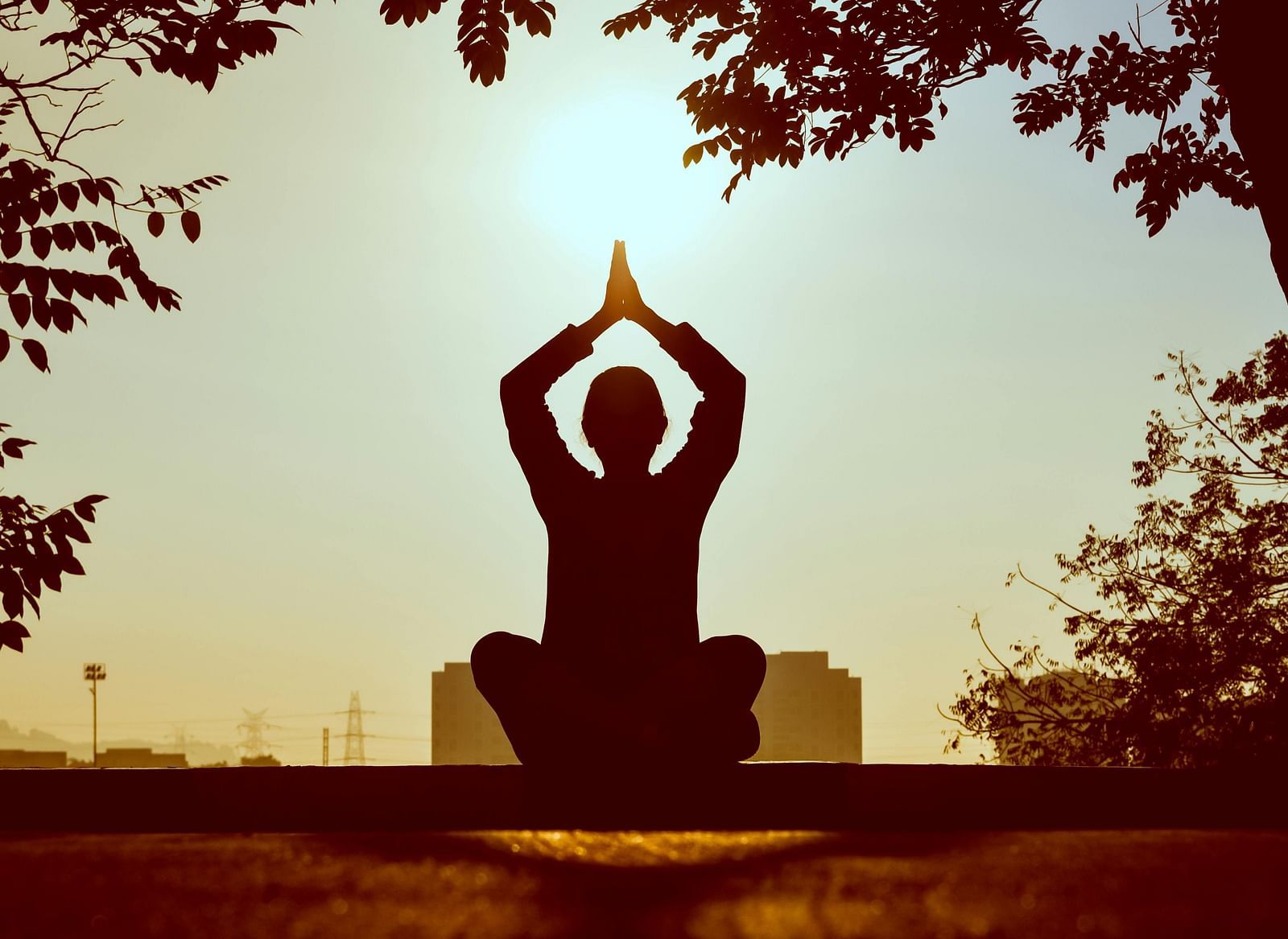 A person doing yoga outdoors in the morning.