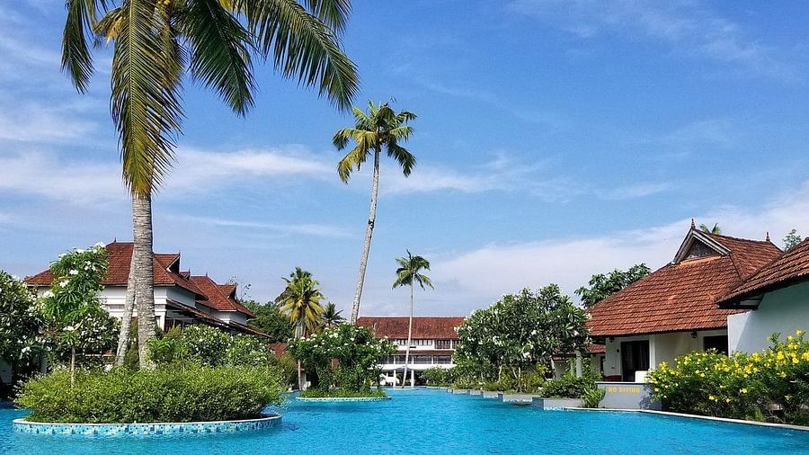 Swimming pool with resort in the backdrop - Rhythm Kumarakom