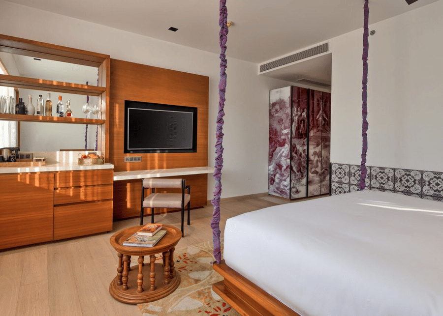 Luxury room with television, furniture and a private bar - Azaya Beach Resort Goa