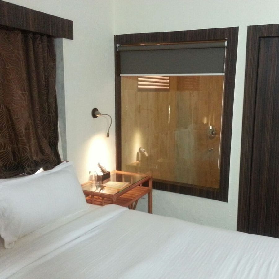 Adamo Resort Matheran - A close up view of bed offered in Bungalow Bedroom 1