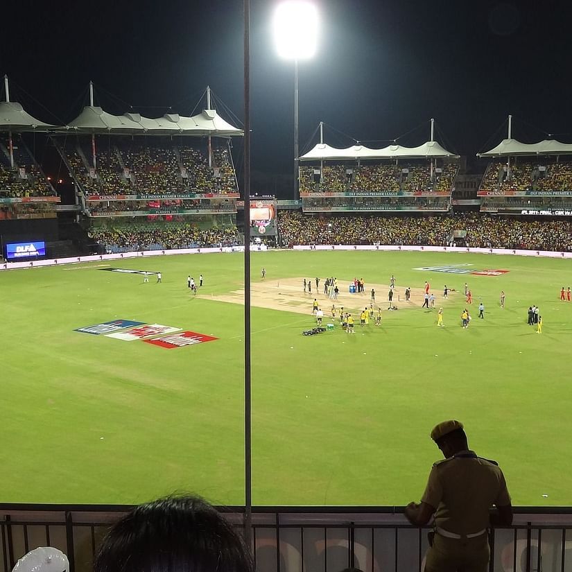 a view of Eden Gardens during night time with flood lights on and players in the ground
