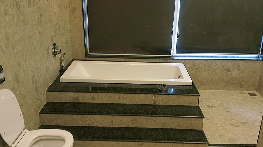 image of the bathroom of the artist suite featuring a bathtub an d a commode besides it