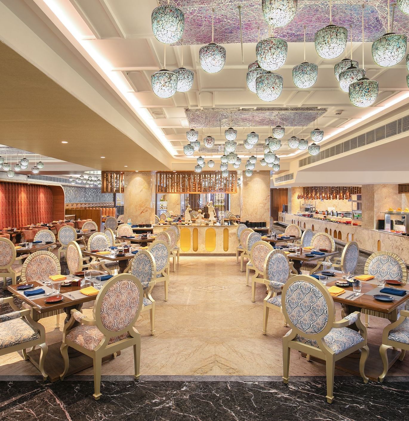 A spacious dining hall featuring modern decor and warm lighting - Kaldan Samudhra Palace