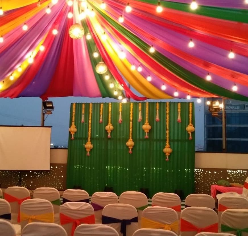 Image of an outdoor event space with chairs and light above at The Oriental Residency
