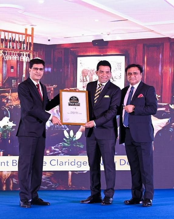 Man receiving the Great Bars of the World award on for the Elephant Bar, Claridges Collection