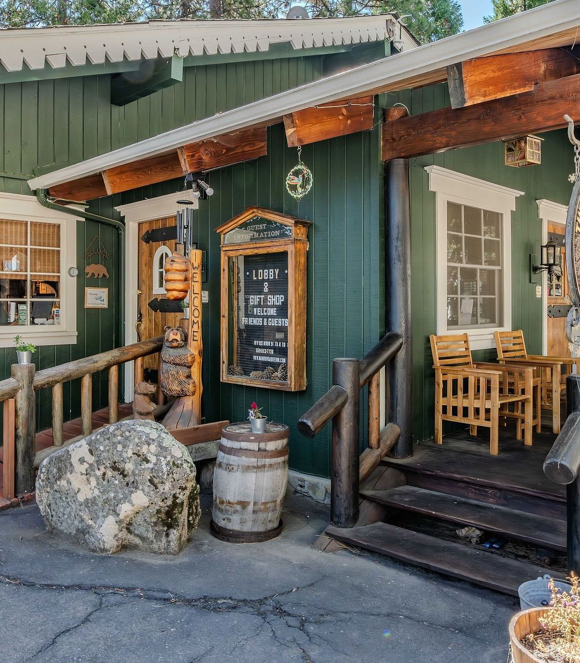 A view of a wooden cabin with pastel green exteriors at Narrow Gauge Inn