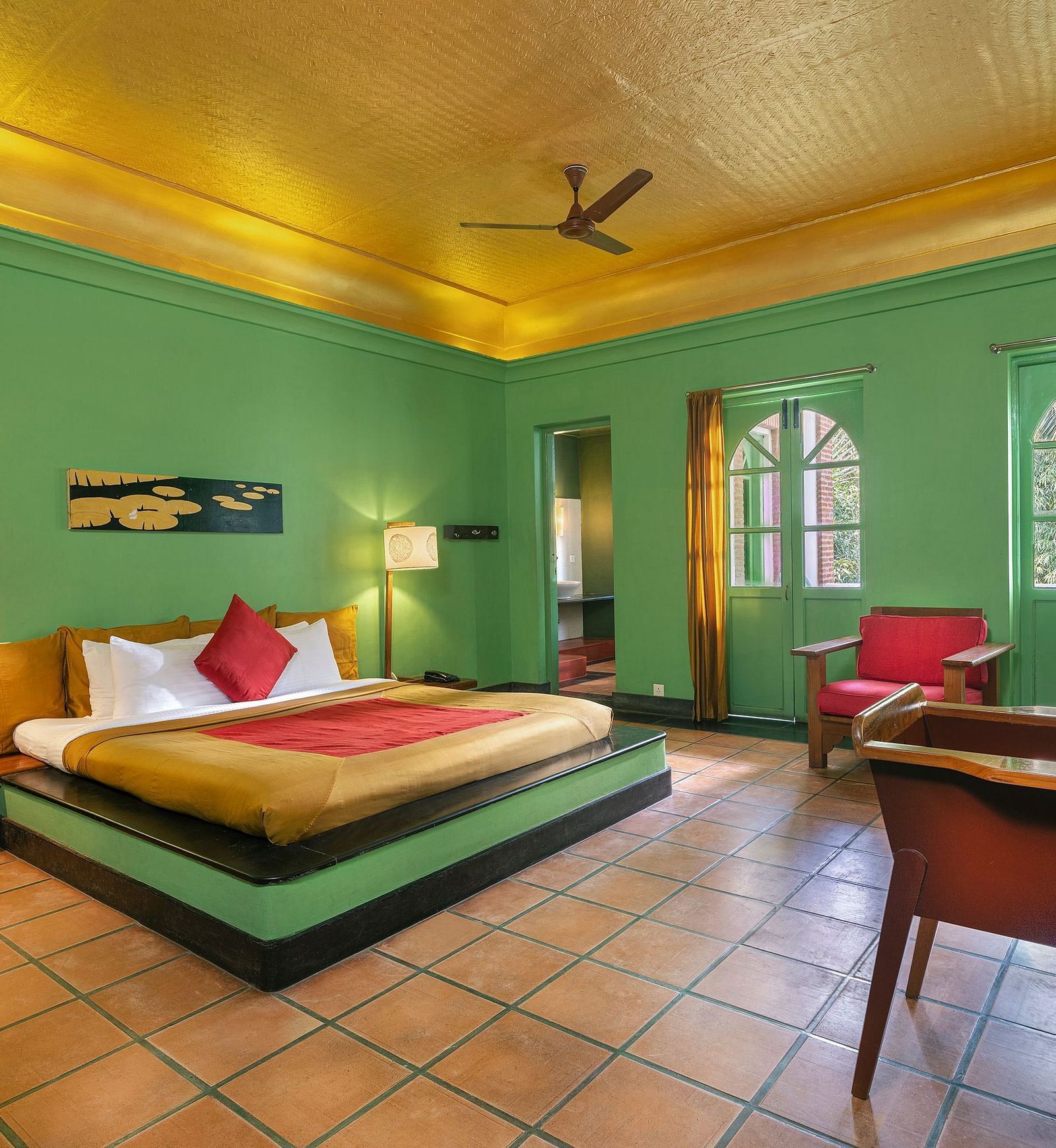 A double bed with side tables and lamps inside the French classic room in Mango Hill, Pondicherry