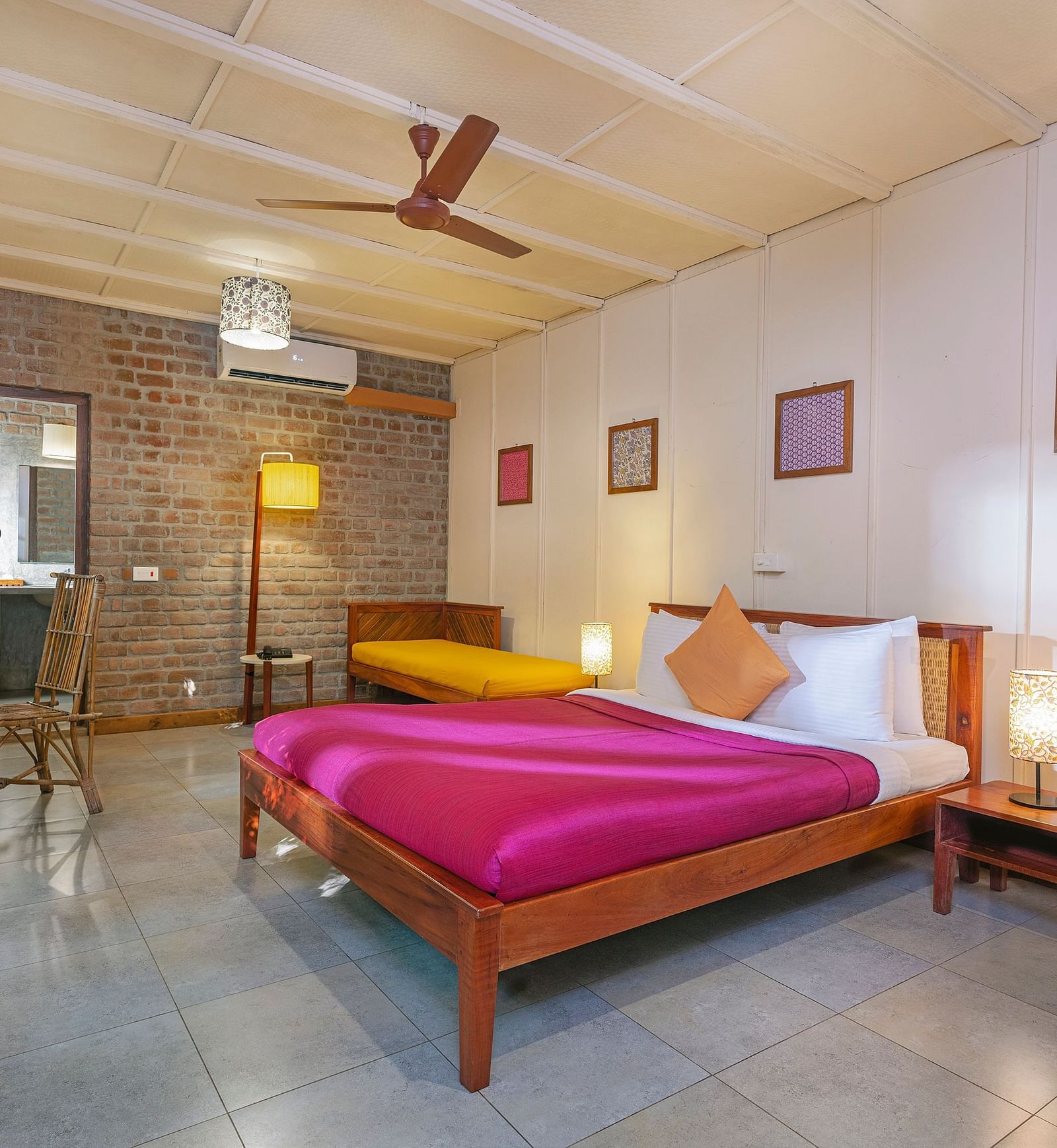 A double bed with side tables and lamps inside Swiss Chalet in Mango Hill, Pondicherry