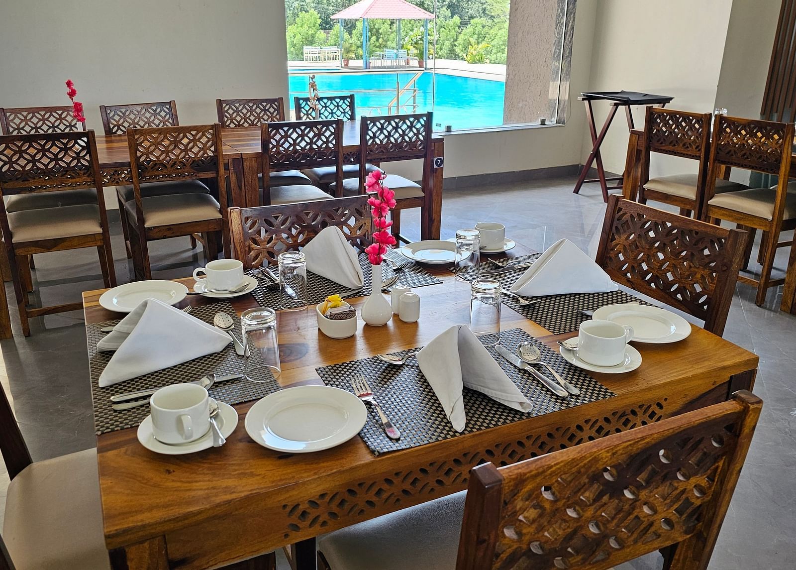 An indoor dining area with a neatly set table with cutlery for four - Bamboo Saa Mulberry Resort, Pushkar