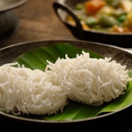 String hoppers (Idiyappam) on a banana leaf.