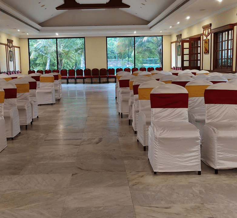 An event space at Avana Resorts, featuring decorated chairs and tables set for an event.