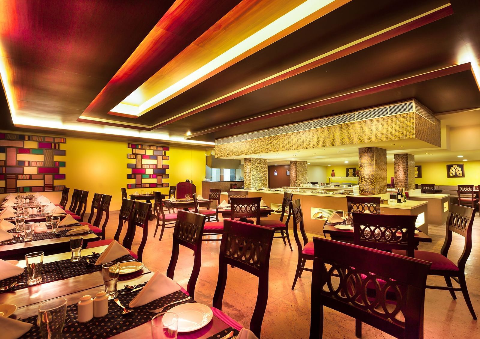 An image of a dining space with tables and chairs | Regency Madurai by GRT Hotels