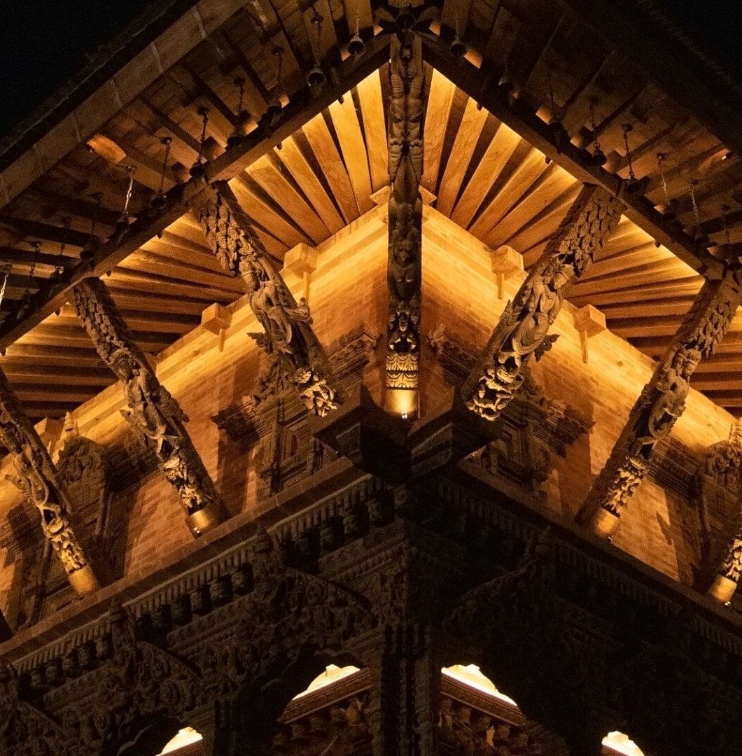 The carvings on a temple structure which is brightly lit
