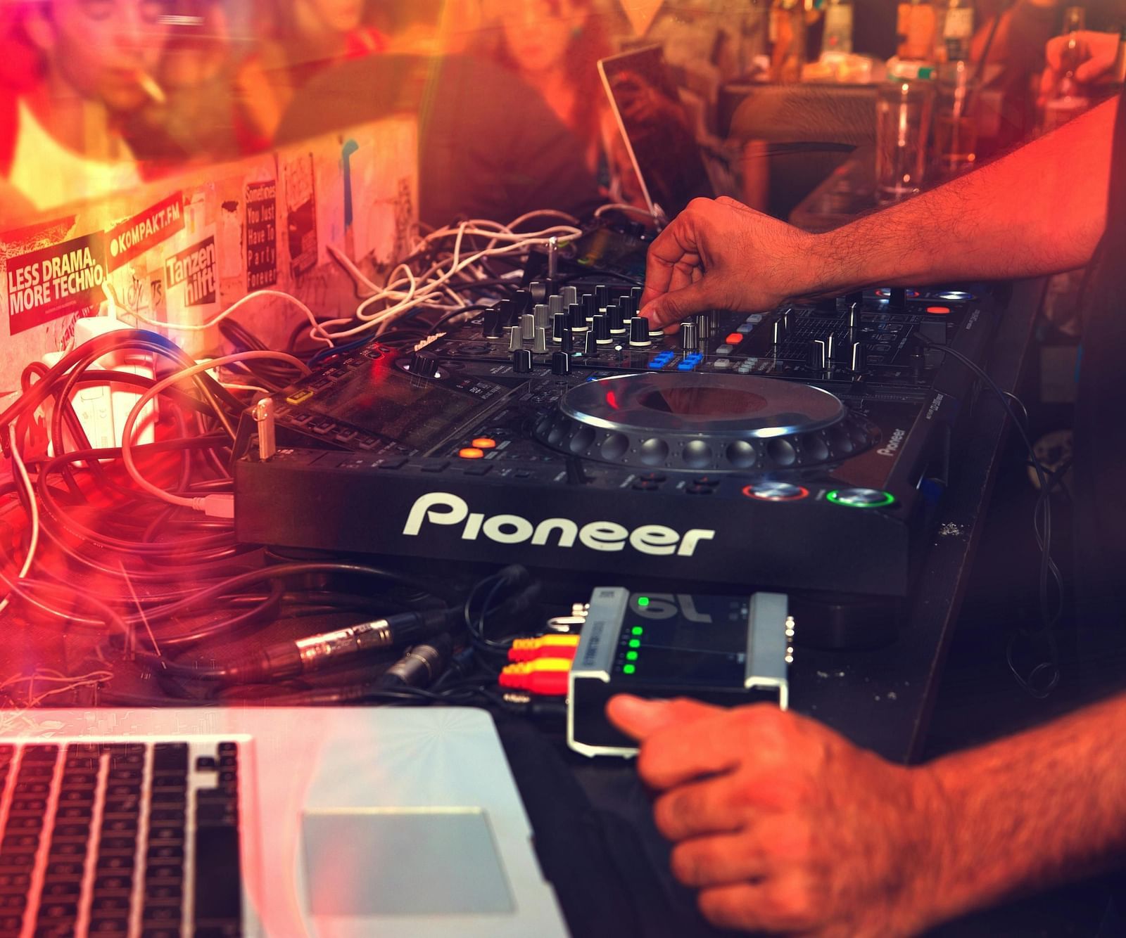 A picture of DJ console and a person using it