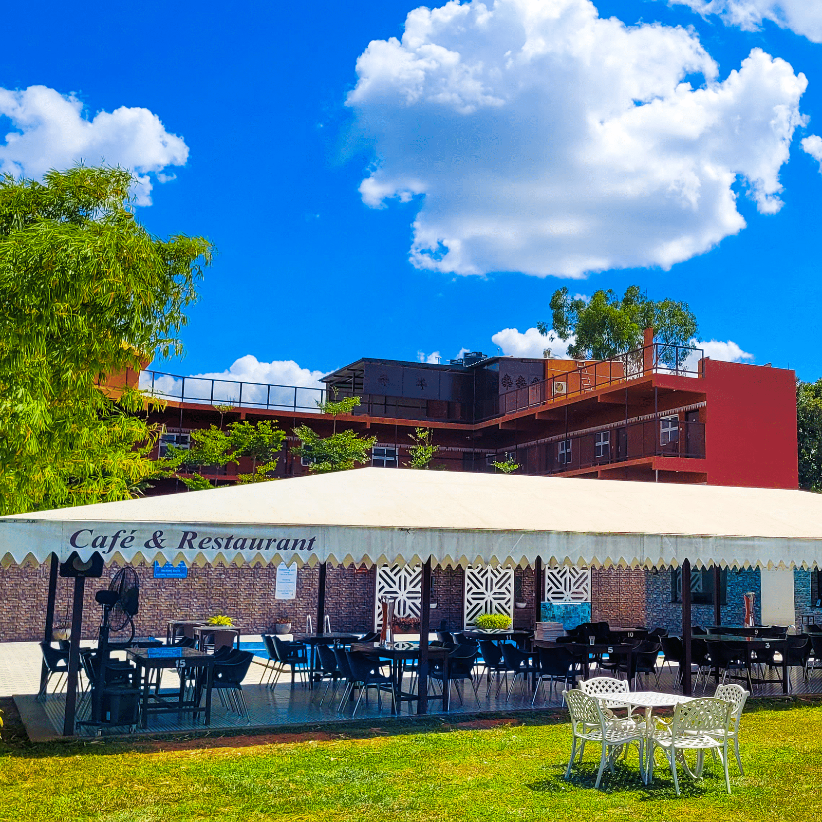 Wide view of a covered restaurant during the day | Vistar Resort, Bengaluru