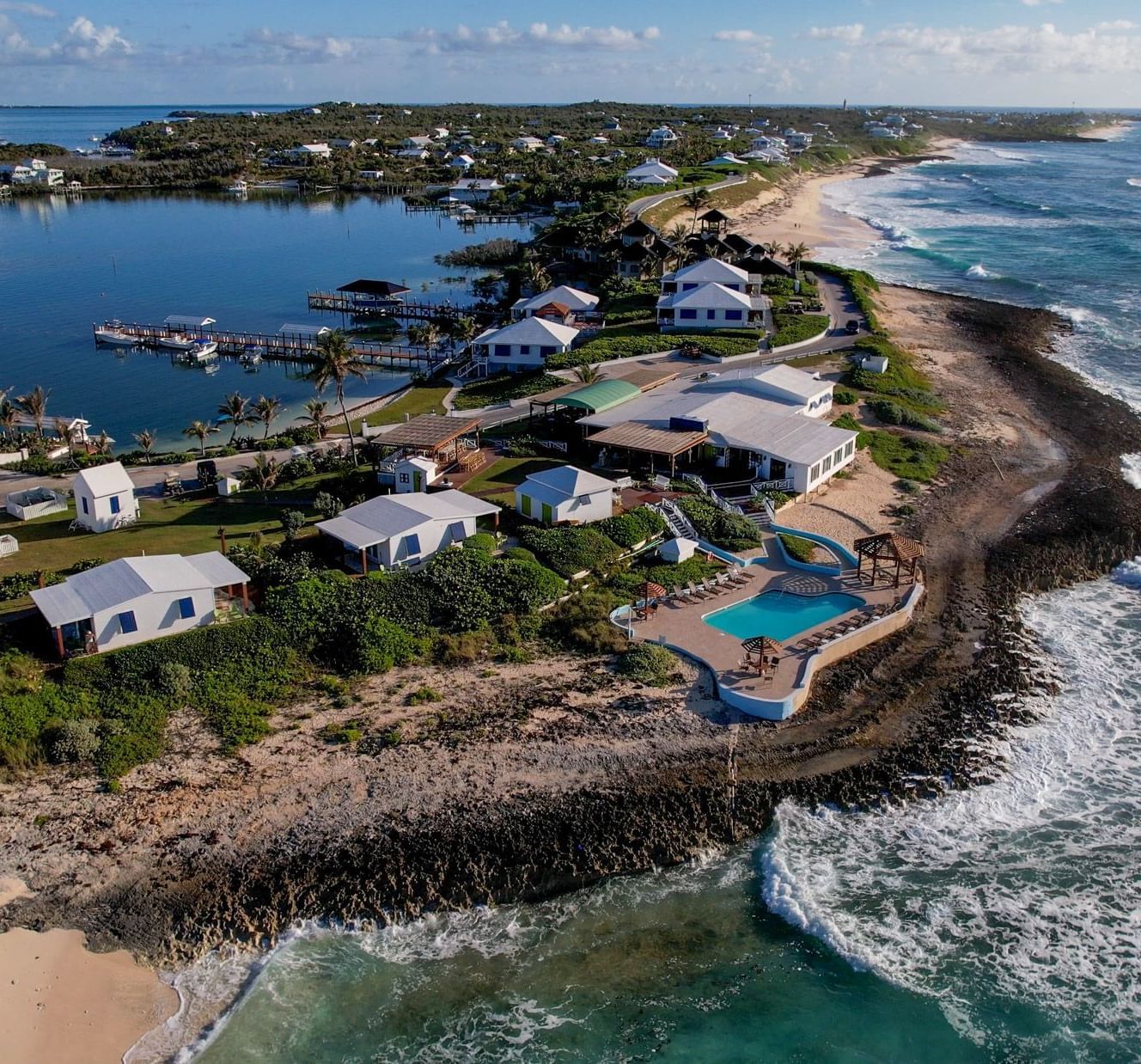 An aerial view of Abaco Inn featuring strong tidal waves crashing on the shores.
