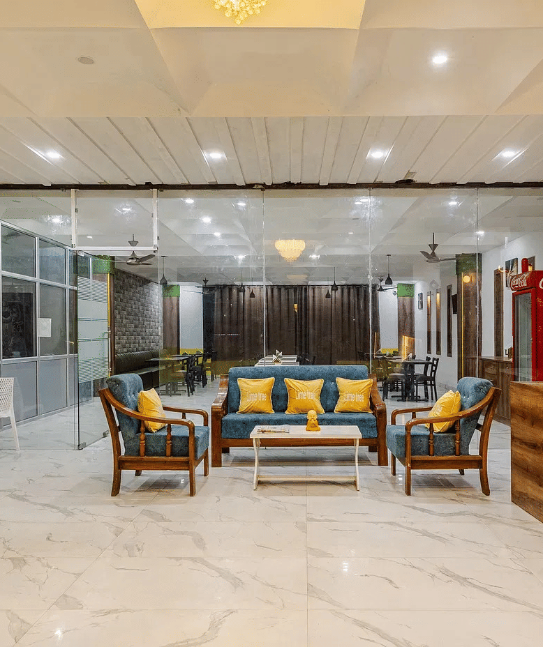 A spacious hotel lobby with a reception desk and multiple seating arrangements - Lime Tree Hotels & Banquet, Vrindavan