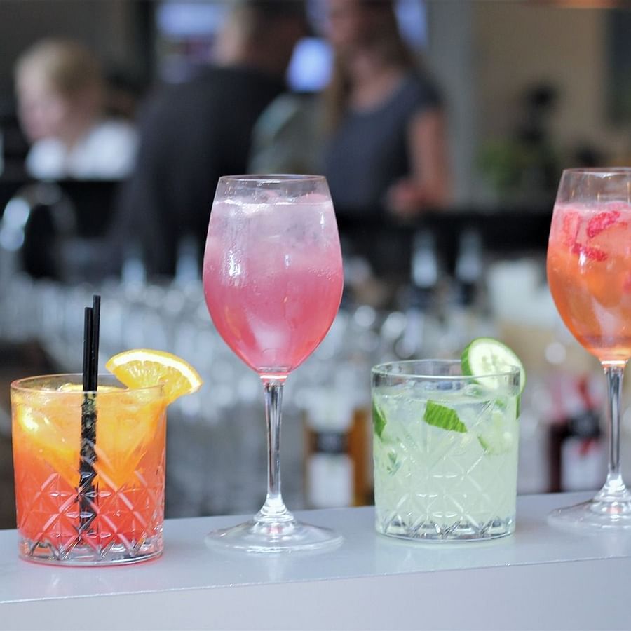 Various colourful drinks placed on a counter in the bar of GK Hill View Resort.