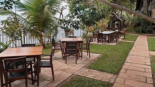 An open-air dining seating at Manger Cafe at Samiira on Ashtamudi Lake.