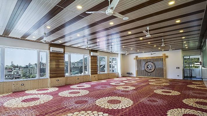An expansive Banquet Hall at Regenta Inn DLS overlooking the beautiful city views from the windows.