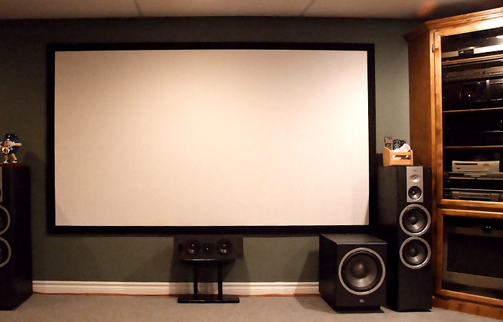 An image of an amphitheatre with white screen and several audio equipment