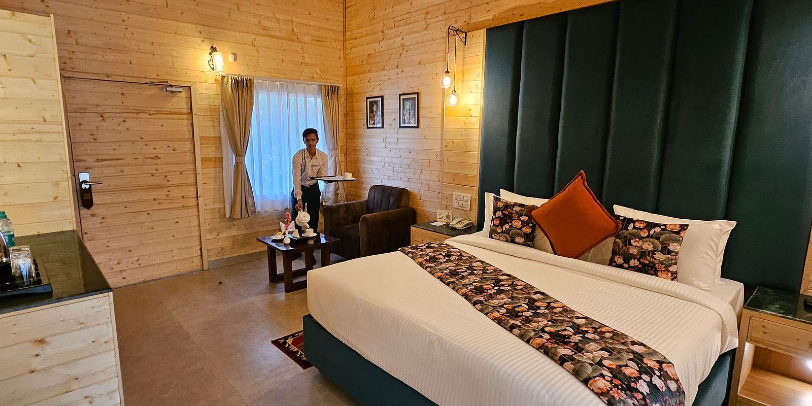 Interior of a hotel room with a made bed, decorative pillows, and a table - Bamboo Saa Mulberry Resort, Pushkar