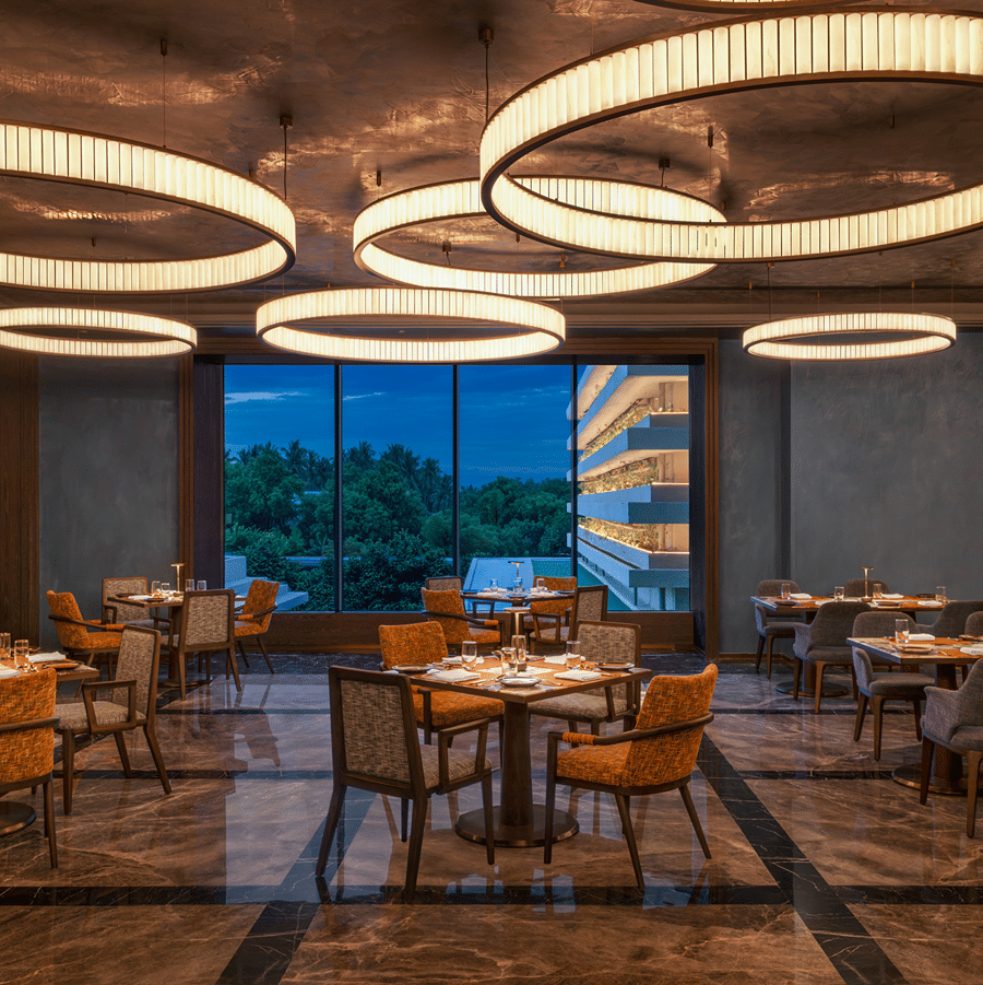 Grand Trunk restaurant seating area with circular pendant lighting at The Residency Signature Madurai.