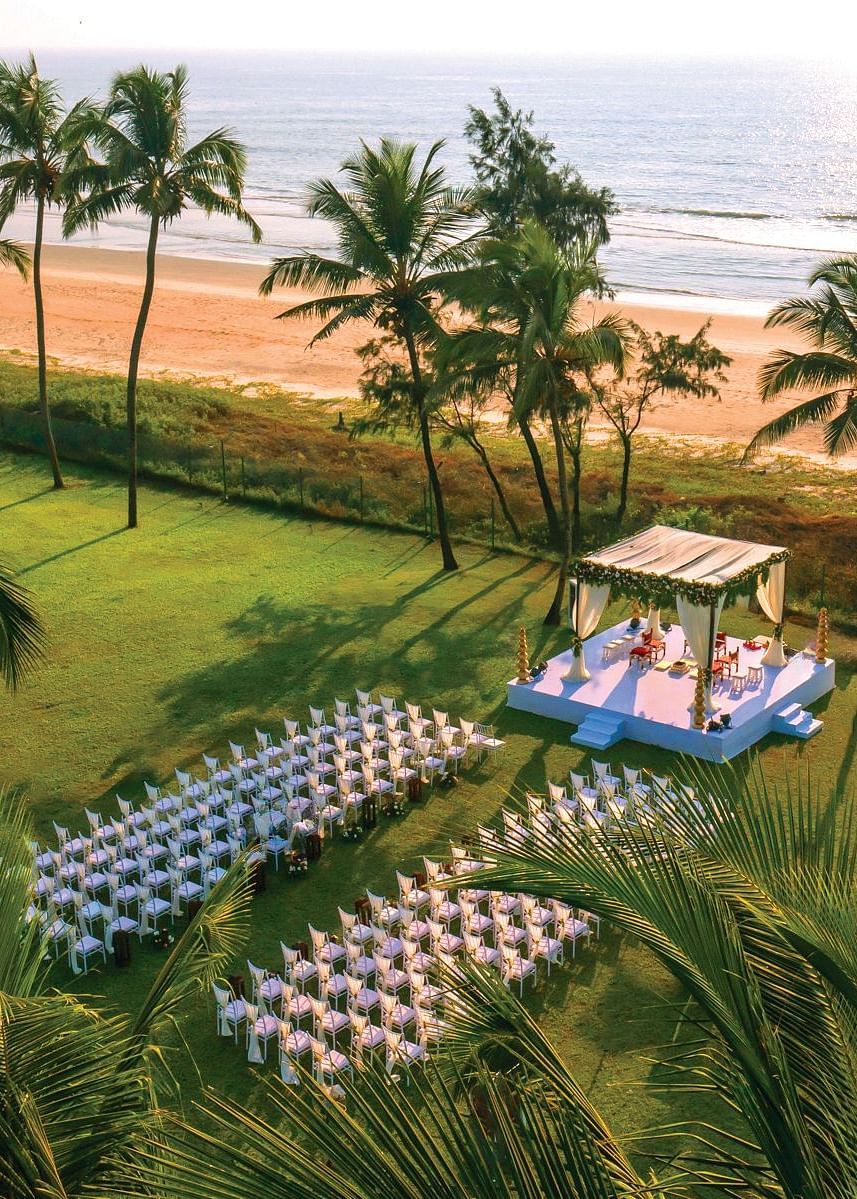aerial view of a wedding with a stage and chairs in view - Caravela Beach Resort Goa