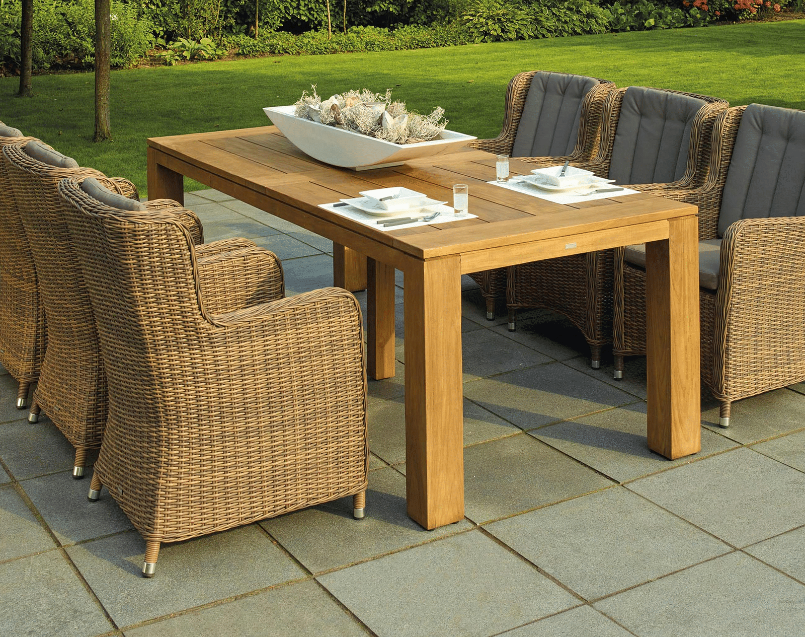An image of a long table with chairs around it in a patio