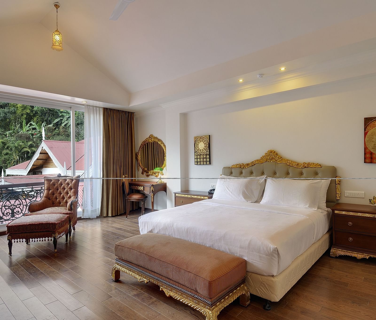 a king size bed and a sofa by the window - Mayfair Spa Resort & Casino Gangtok