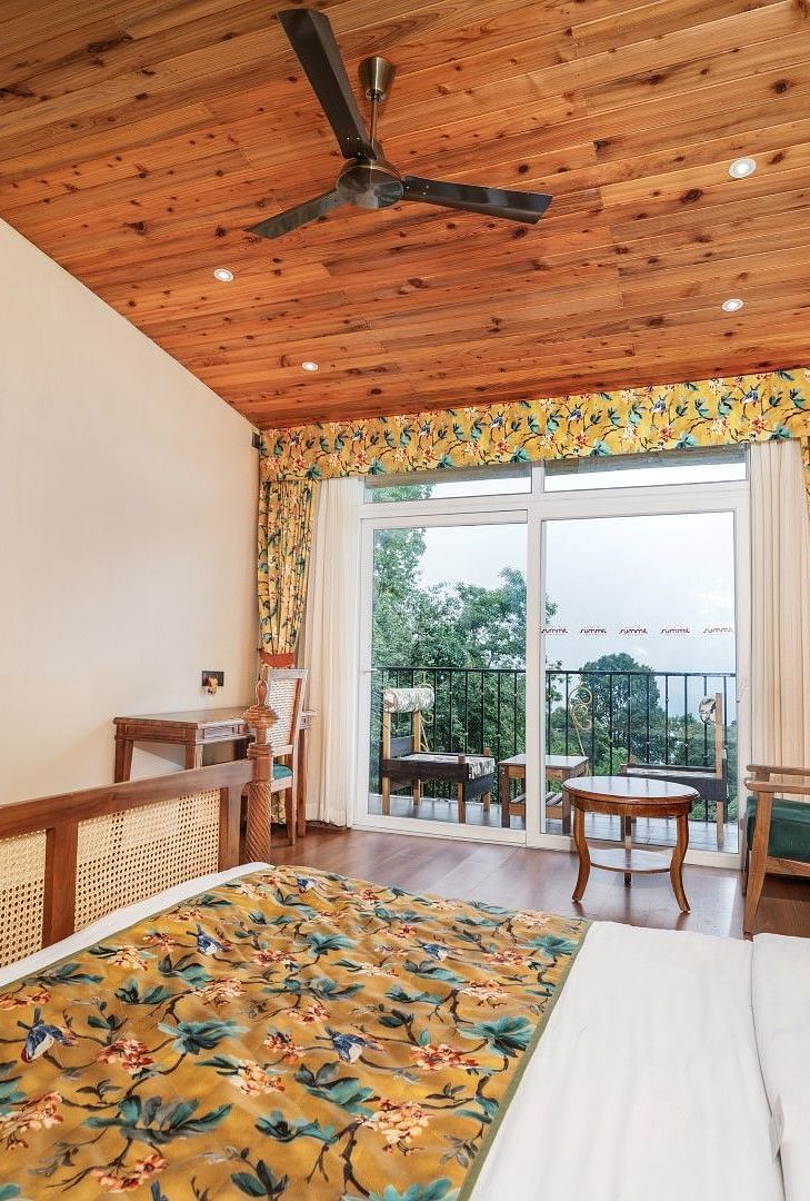 A room at Summit Barsana Resort & Spa, Kalimpong with a double bed, a television and a balcony