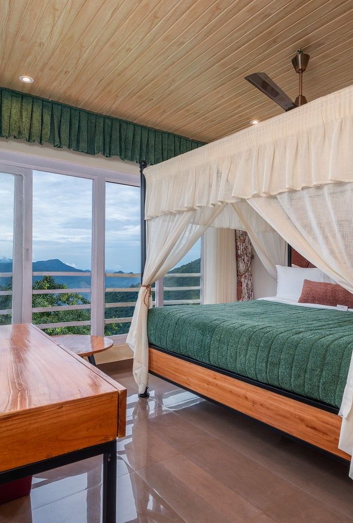 A spacious bed with ample lighting, complemented by wooden furniture