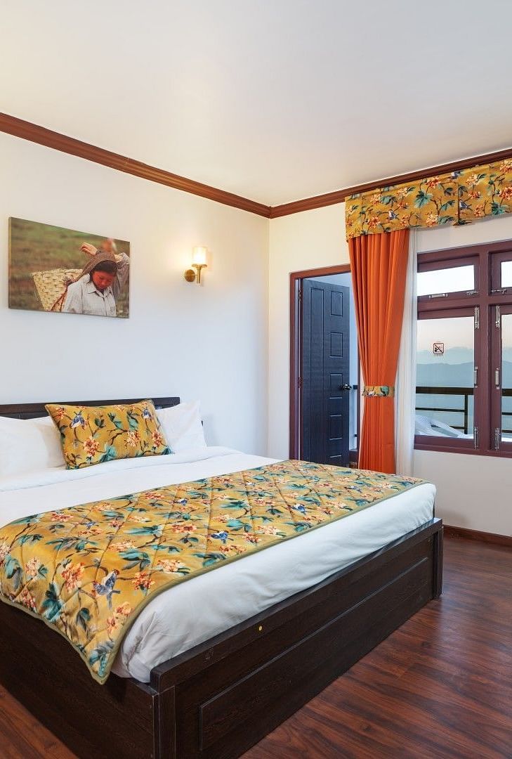 Image of a room with a bed and seating area at Summit Sherpa Mountain Hotel & Spa, Kalimpong