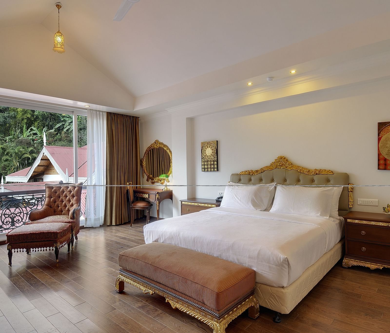 a king size bed and a sofa by the window - Mayfair Spa Resort & Casino Gangtok