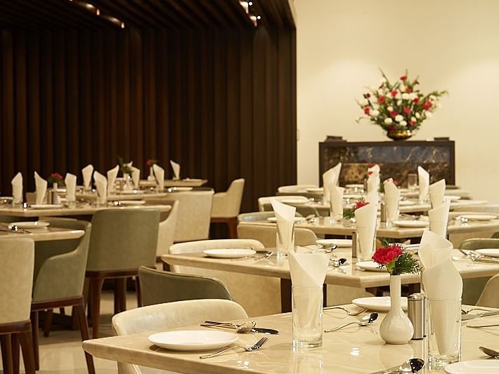 Variously arranged seating area at a restaurant at The Hamuse Hotel, Kodaikanal.