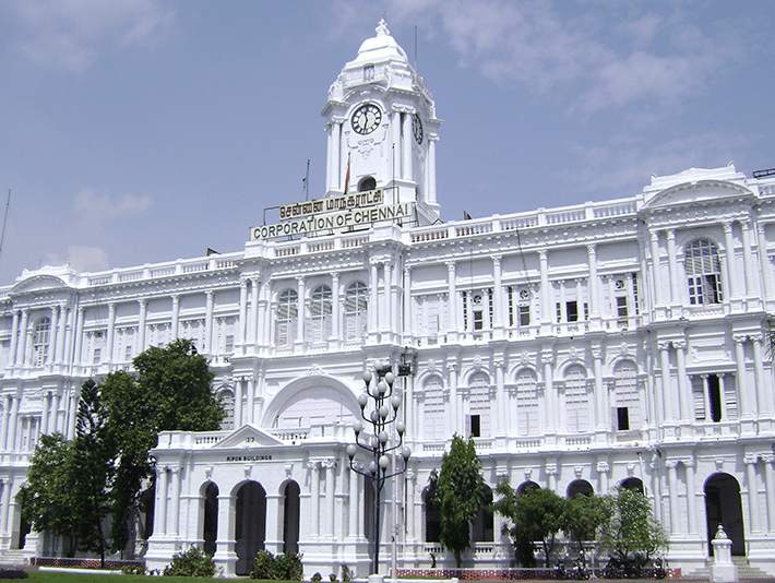 A grand white colonial-style building with a clock tower.